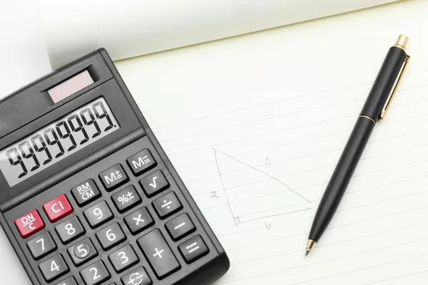 Calculator pen on book — Stock Photo, Image