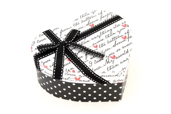 Perspective of isolated black and white holiday gift box in hear — Stock Photo, Image