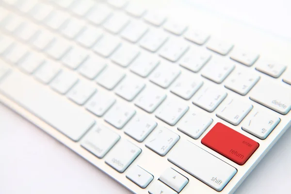 Perspective of red return button on white modern keyboard — Stock Photo, Image