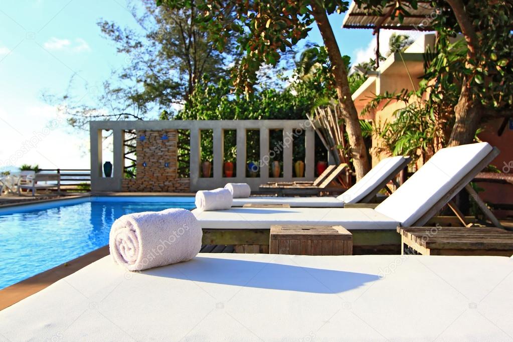 White Towel on Beach chair and Swinm pool