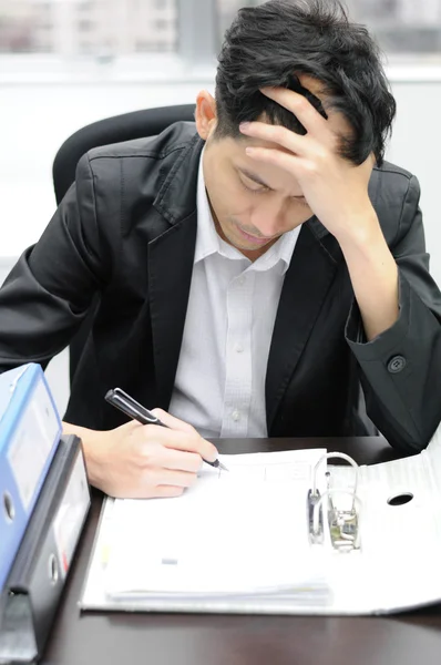 Thoughtful or stressful businessman at work — Stock Photo, Image