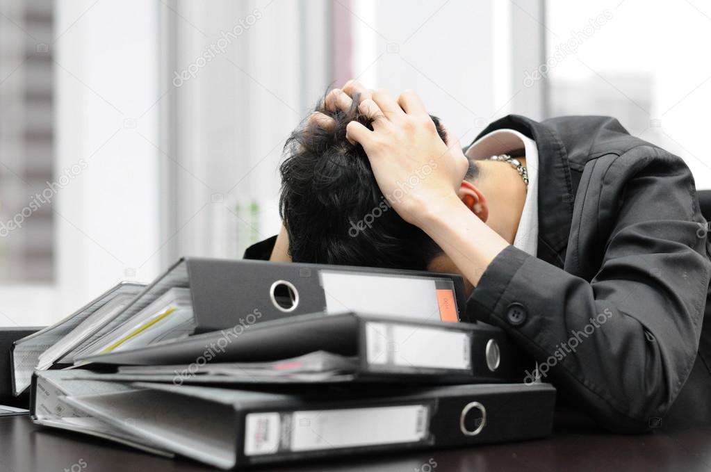 Thoughtful or stressful businessman at work