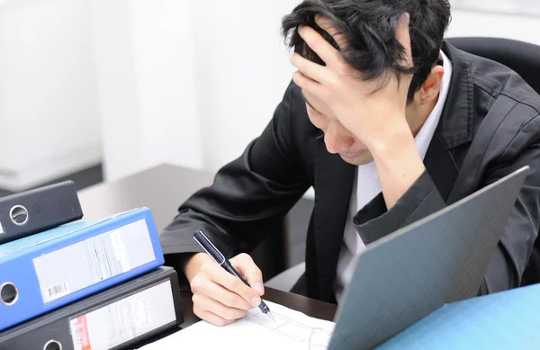 Thoughtful or stressful businessman at work — Stock Photo, Image