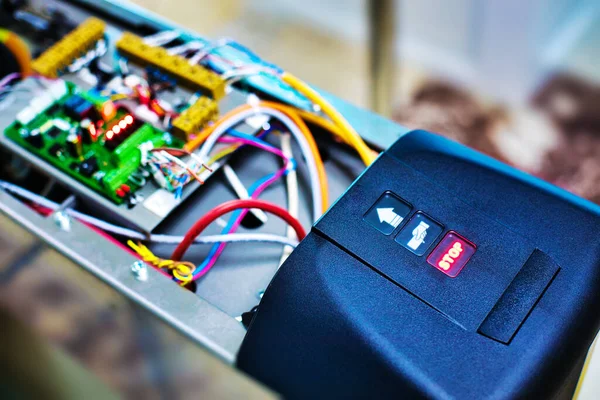 Setting up the turnstile for passing at the entrance. Device with wires and chips.