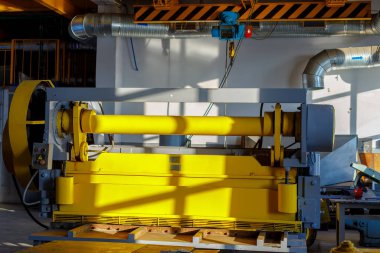 Metal kesme makinesi üretim salonunda. Çalışan iç mekanlarda endüstriyel ekipman.