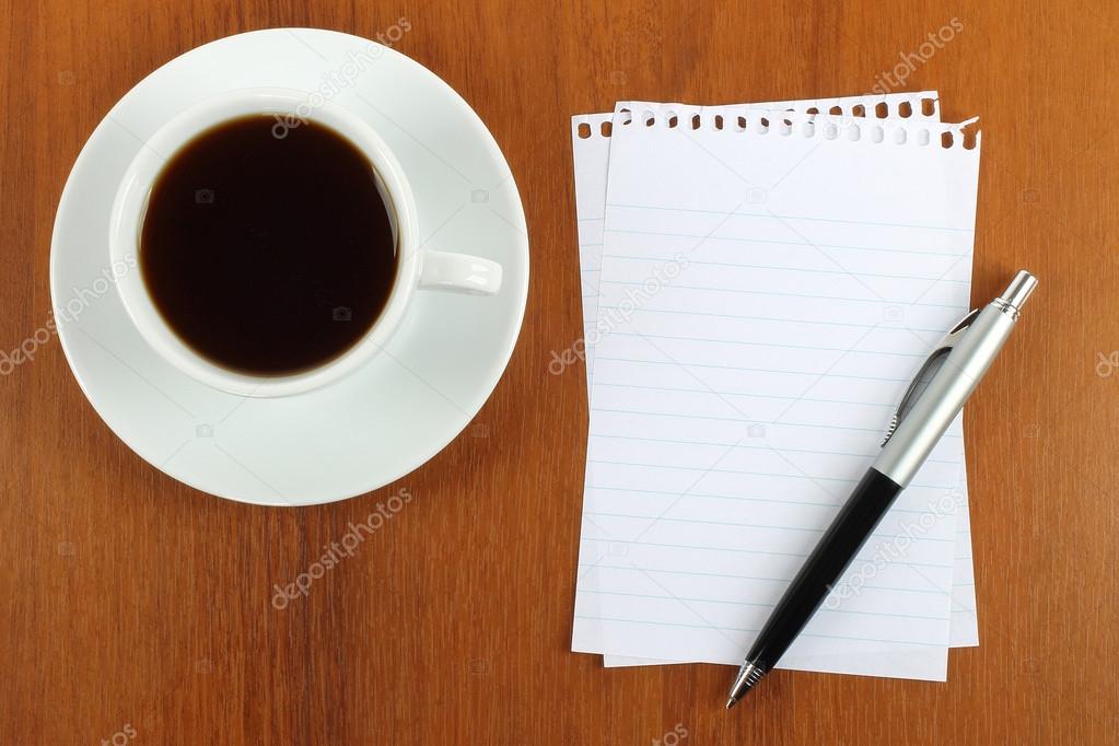 Cup of coffee, paper and pen