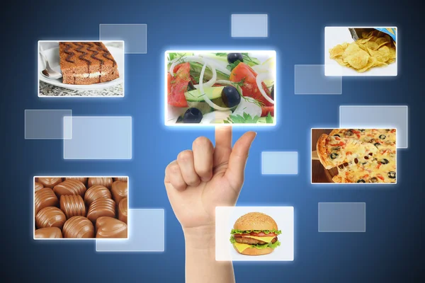 Woman hand uses touch screen interface with food — Stock Photo, Image