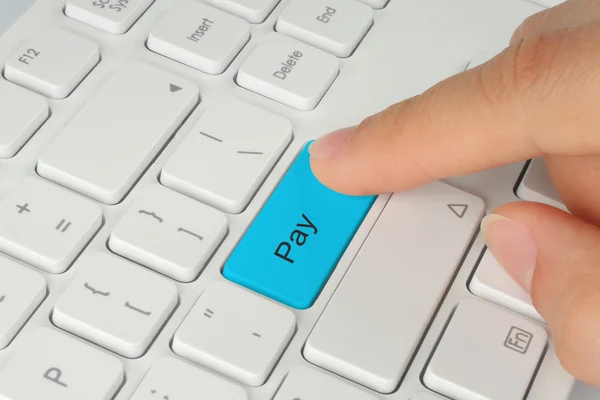 Hand pushing blue pay button — Stock Photo, Image