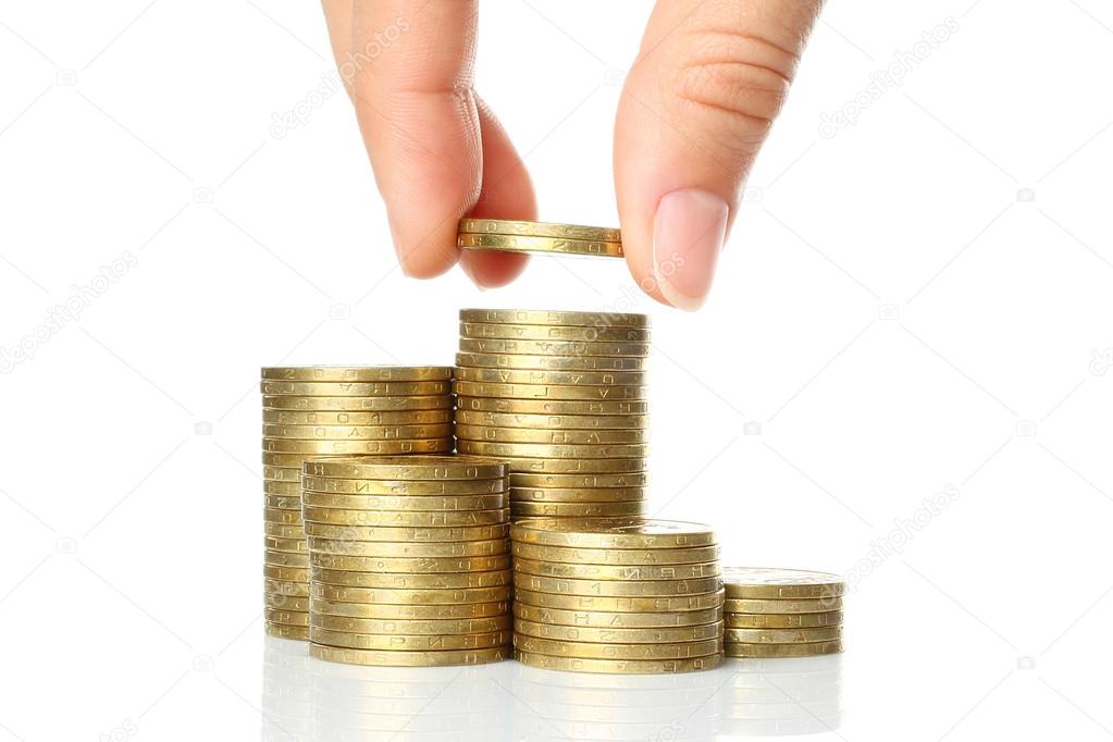 Hand put coins to stack of coins