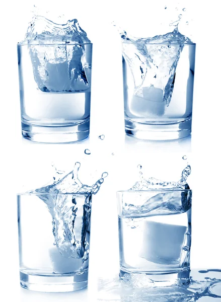 Ice in glass of water with splash set — Stock Photo, Image