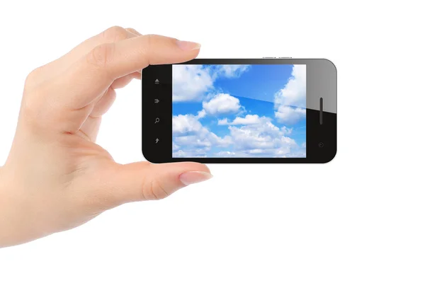 Mujer de la mano sostiene el teléfono inteligente con el cielo — Foto de Stock