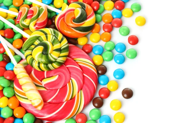 Colorful spiral lollipop with chocolate coated candy — Stock Photo, Image