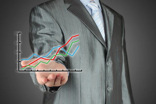 Affärsman som innehar ett finansiella diagram — Stockfoto