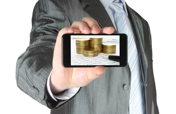 Man holds smart phone with business composition of graphs and money — Stock Photo, Image