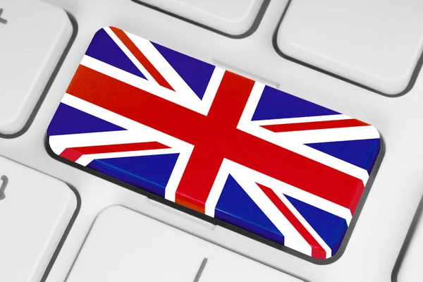 ホワイトコンピュータのキーボードの閉じる上の英国のフラグを持つボタン — ストック写真