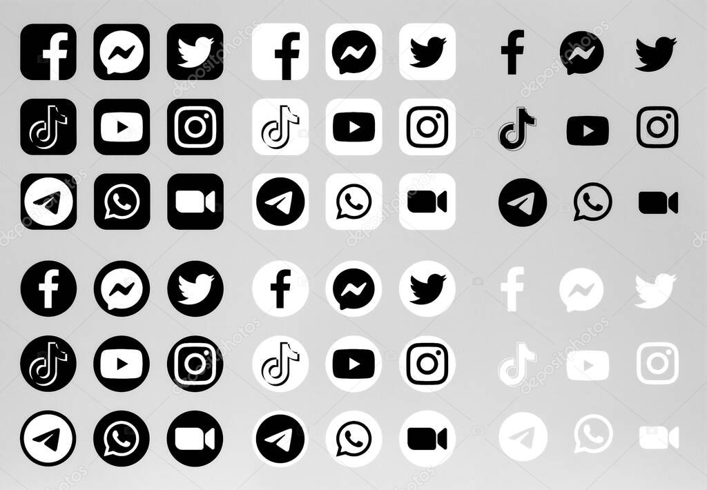 Kiev, Ukraine - September 27, 2021: Set of popular black and white apps symbols and icons: Facebook, Instagram, Twitter, Messenger, Tiktok, and others, printed on paper