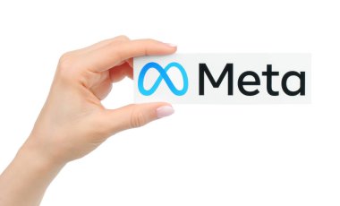 Kiev, Ukraine - January 20, 2022: Hand holds Meta logo, printed on paper. Social media giant Facebook is rebranding as Meta
