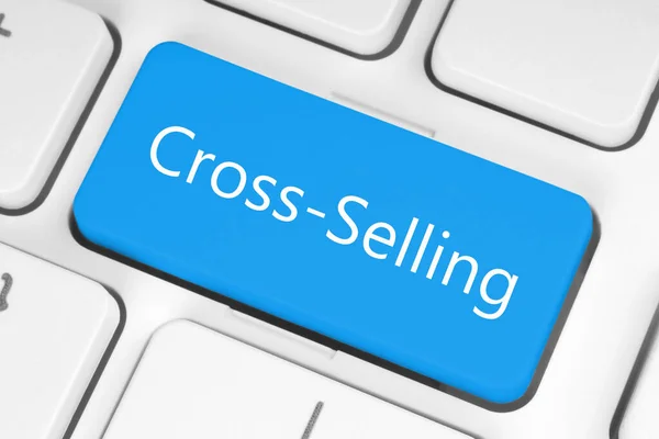 Blue button with Cross-Selling words on the keyboard close-up, technology and business concept