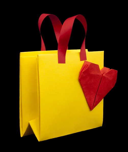 Yellow shopping bag with red heart — Stock Photo, Image