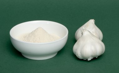 Crushed garlic powder and whole garlic clipart