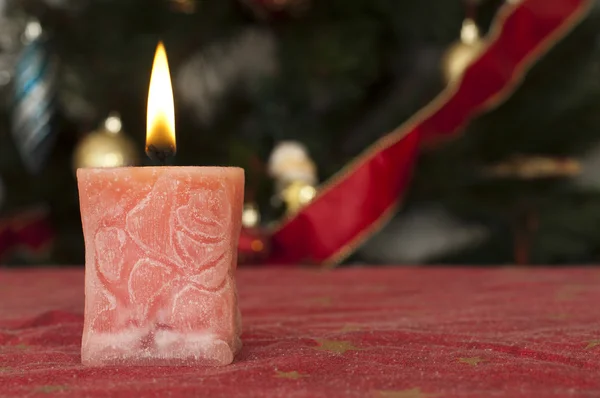 Christmas candle on the festive table — Stock Photo, Image