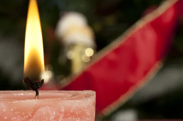 Christmas candle on the festive table — Stock Photo, Image