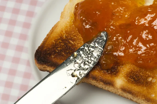 Spread jam on bread — Stock Photo, Image