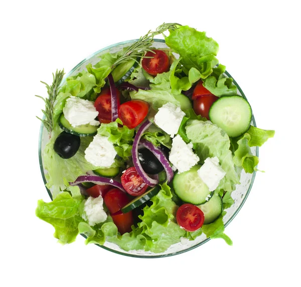 Salade dans un bol en verre sur fond blanc — Photo