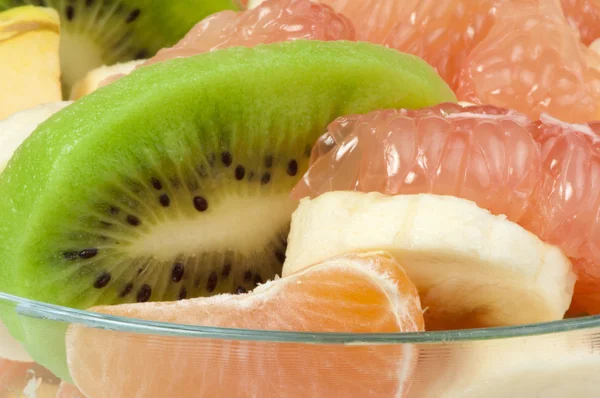 Fruit salad with citrus in a glass bowl — Stock Photo, Image