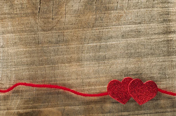 Red ribbon tape and two hearts — Stock Photo, Image