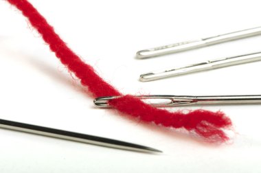 Sewing needles and red thread clipart