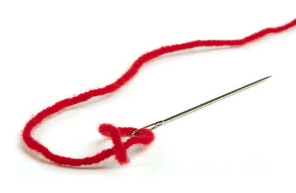 Sewing needle and red thread — Stock Photo, Image