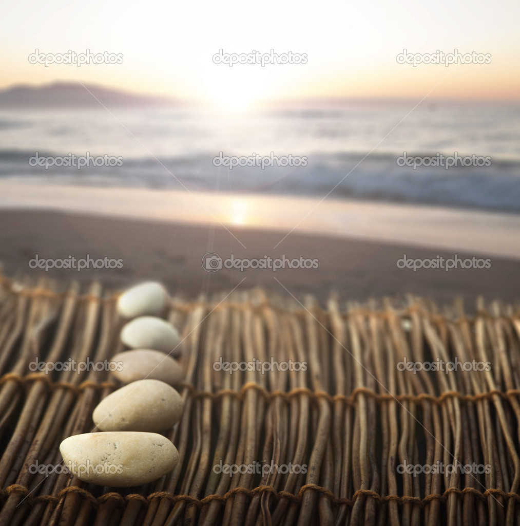 Sequence of stones on wooden base for spa