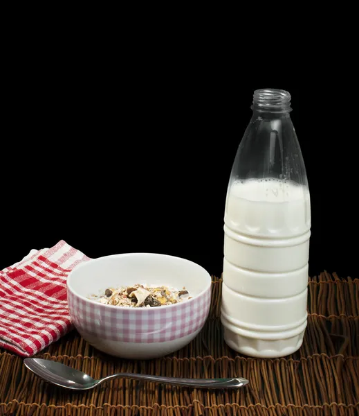Muesli breakfast in a bow, spoon and milk — Stock Photo, Image
