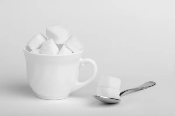 Sugar lumps in cup — Stock Photo, Image