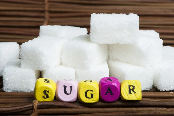 Socker klumpar och text — Stockfoto