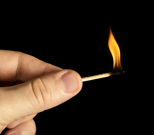 Mão segurando queima jogo vara — Fotografia de Stock