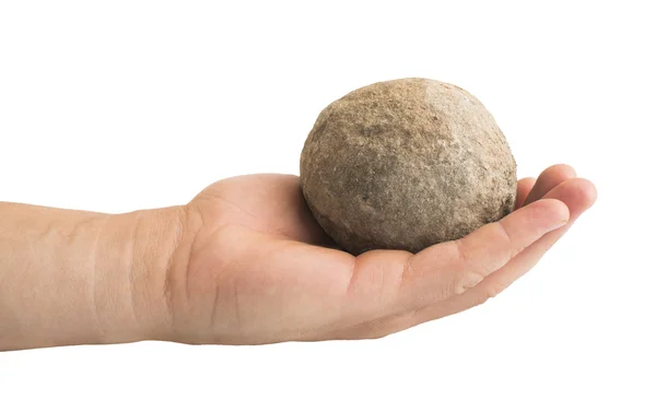 Рука тримає кам'яний м'яч — стокове фото