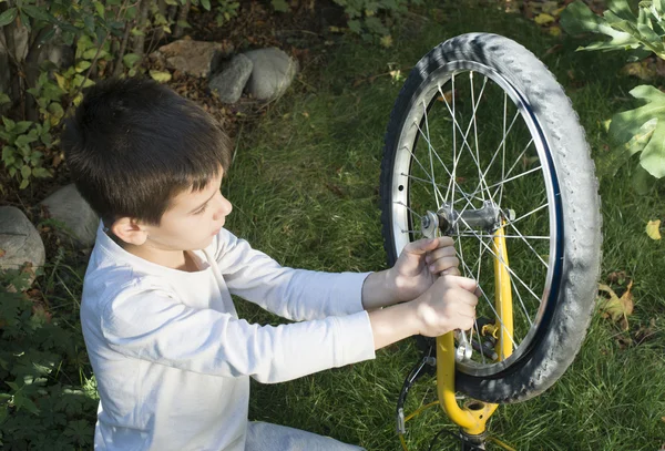 Un gamin qui répare des vélos — Photo