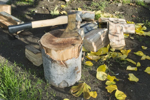 Ax chopping wood on chopping block — Stock Photo, Image