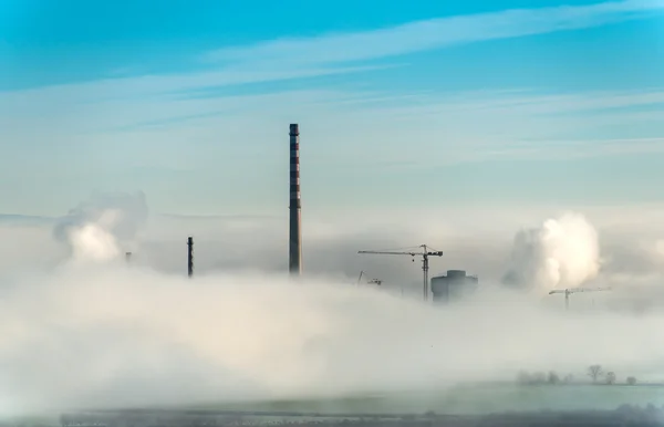 Factory chimneys and clouds of steam — Stock Photo, Image