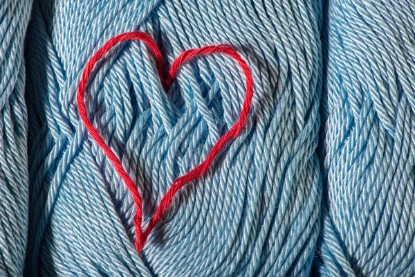 Knitted red heart on blue — Stock Photo, Image