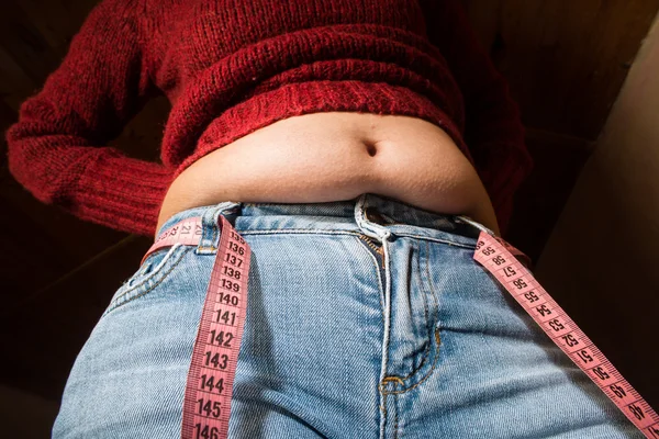 Woman showing fat belly — Stock Photo, Image