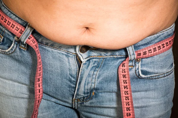 Woman showing fat belly — Stock Photo, Image