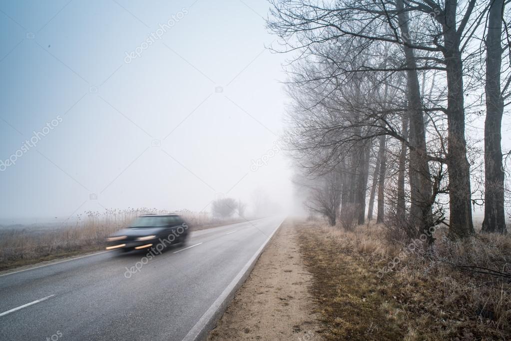 Car on a road in fog