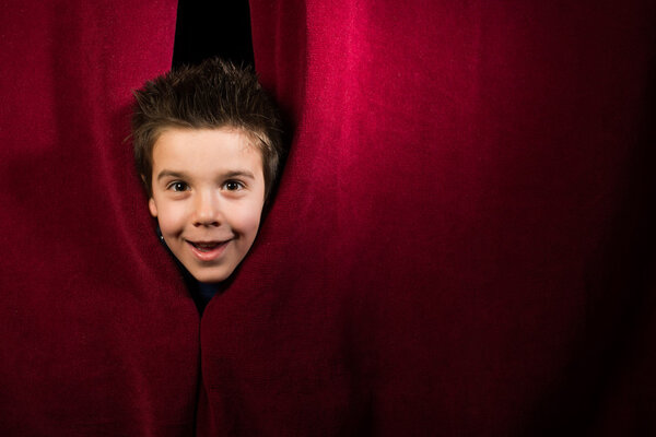 Child appearing beneath the curtain