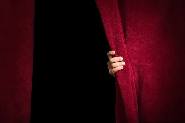 Hand appearing beneath the curtain. — Stock Photo, Image