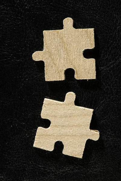 Wooden puzzle on black background — Stock Photo, Image