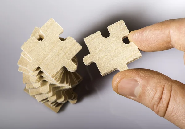 Wooden puzzle on white background. — Stock Photo, Image