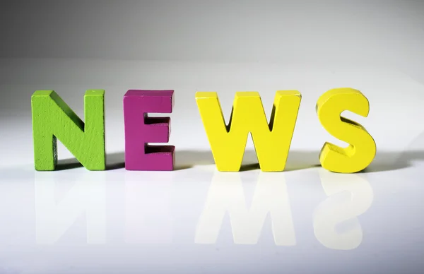 Multicolored word news made of wood. — Stock Photo, Image